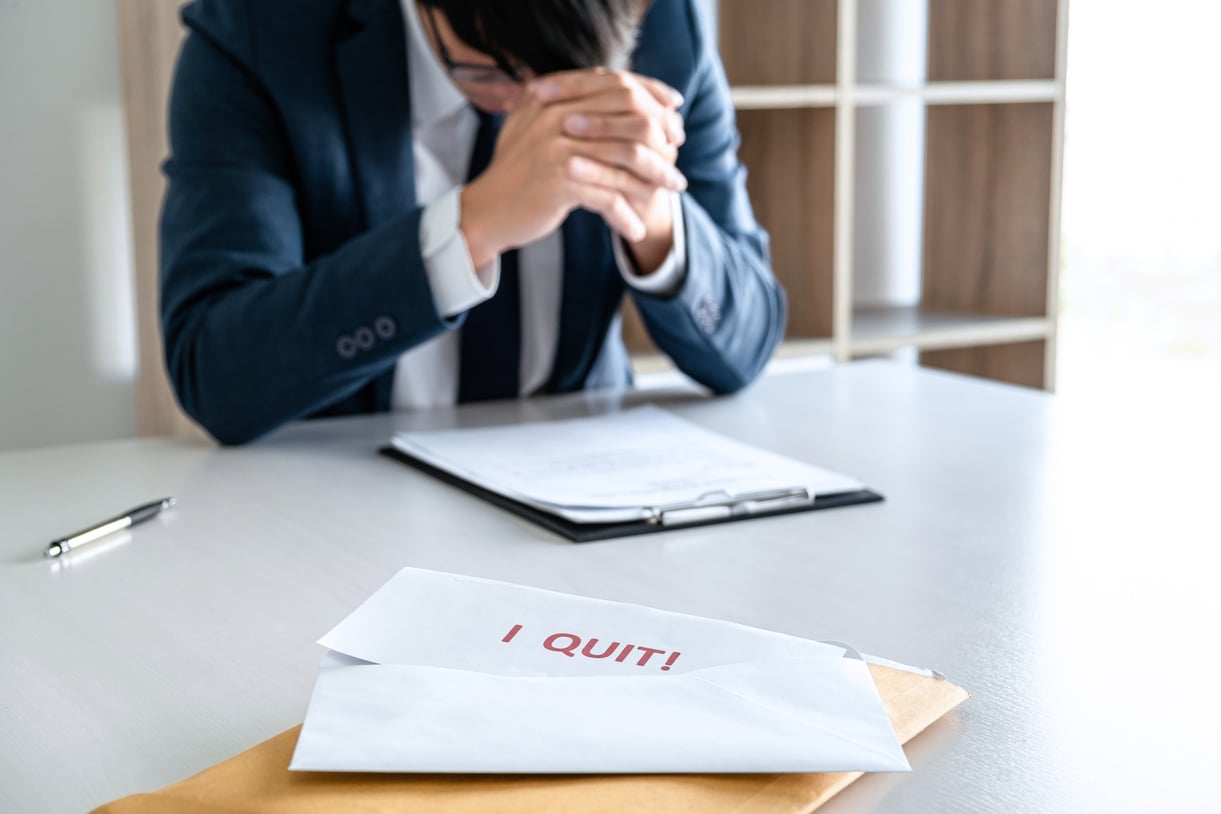 Unhappy Man Submitting a Resignation Letter 